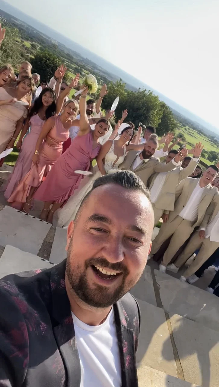 Selfie von Hochzeitsmoderator Andrey Singer mit winkenden Gästen und Brautpaar in Paphos, Zypern Selfie von Hochzeitsmoderator Andrey Singer mit winkenden Gästen und Brautpaar in Paphos, Zypern